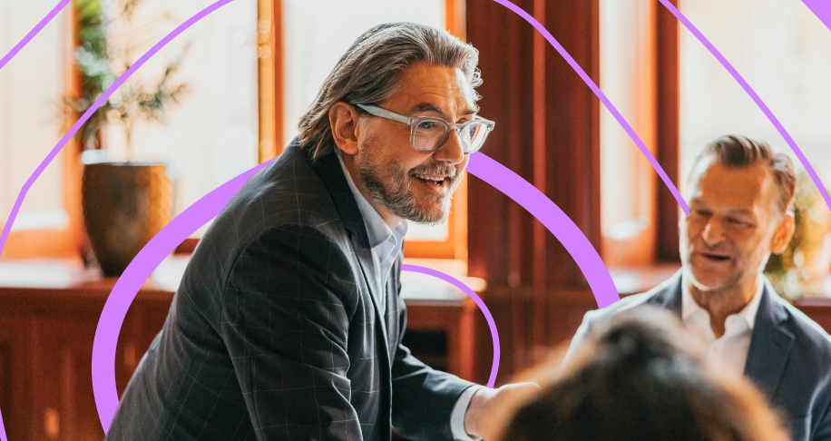 Man wearing glasses, speaking to a group