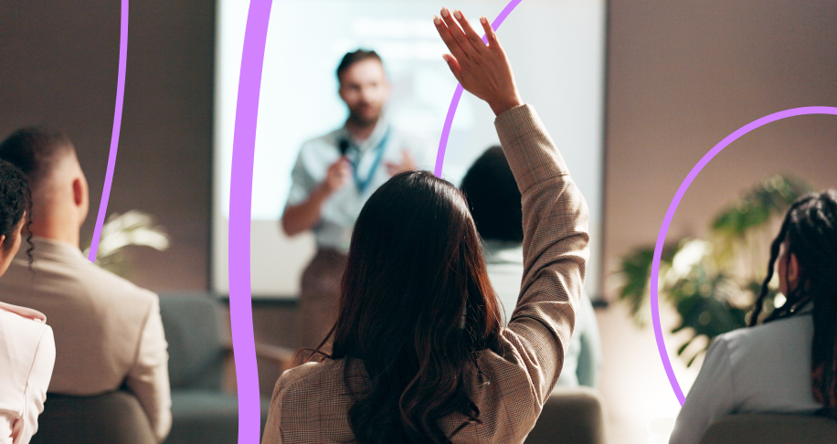 Woman raising hand in audience