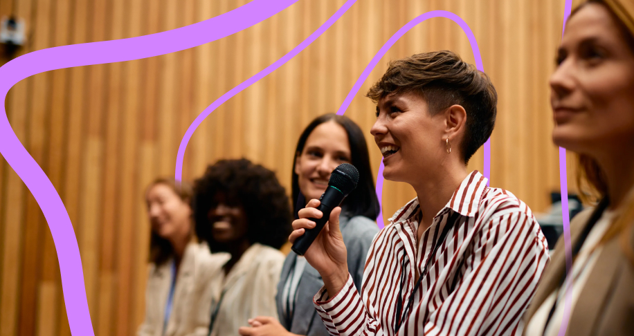 Woman in audience speaking into microphone