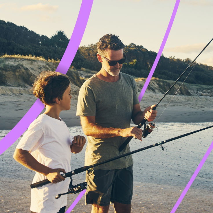 father teaches son to use fishing rod